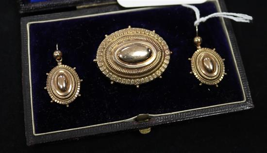 A Victorian 9ct gold oval brooch and matching pair of earring in fitted box.